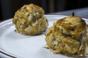 two lump crab cakes on a plate side by side