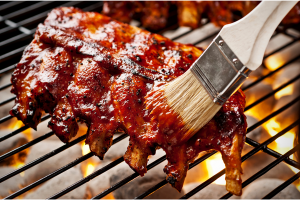 Bbq ribs being grilled and sauced